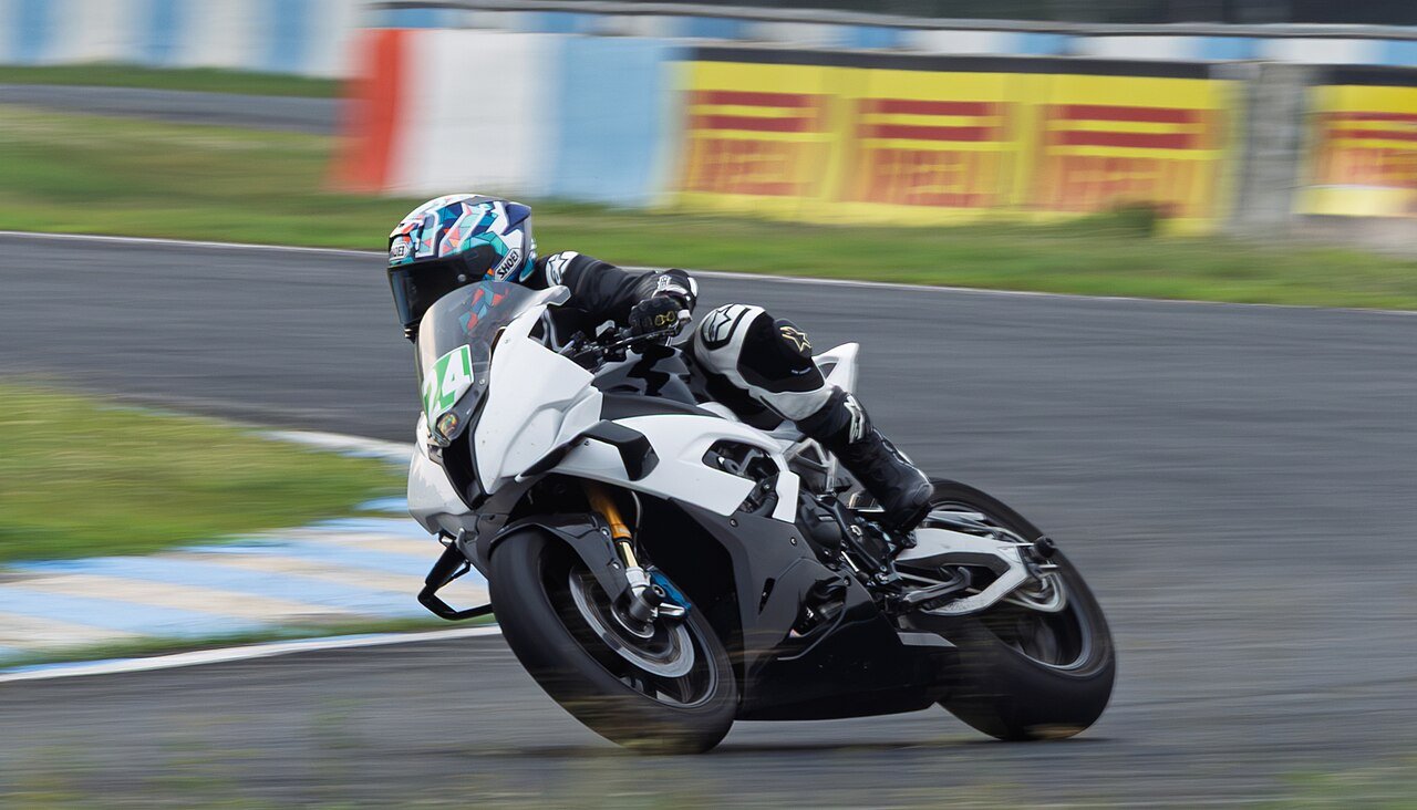 BMW S1000RR sportbike — track riders commonly run one tooth smaller up front and two larger at the rear