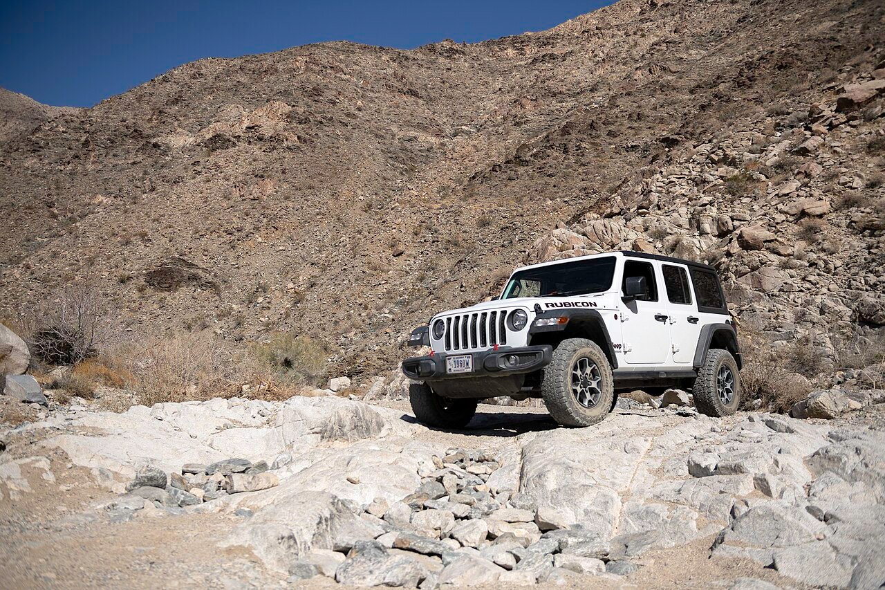 Jeep rock crawling at walking pace — a deep crawl ratio is what makes this control possible